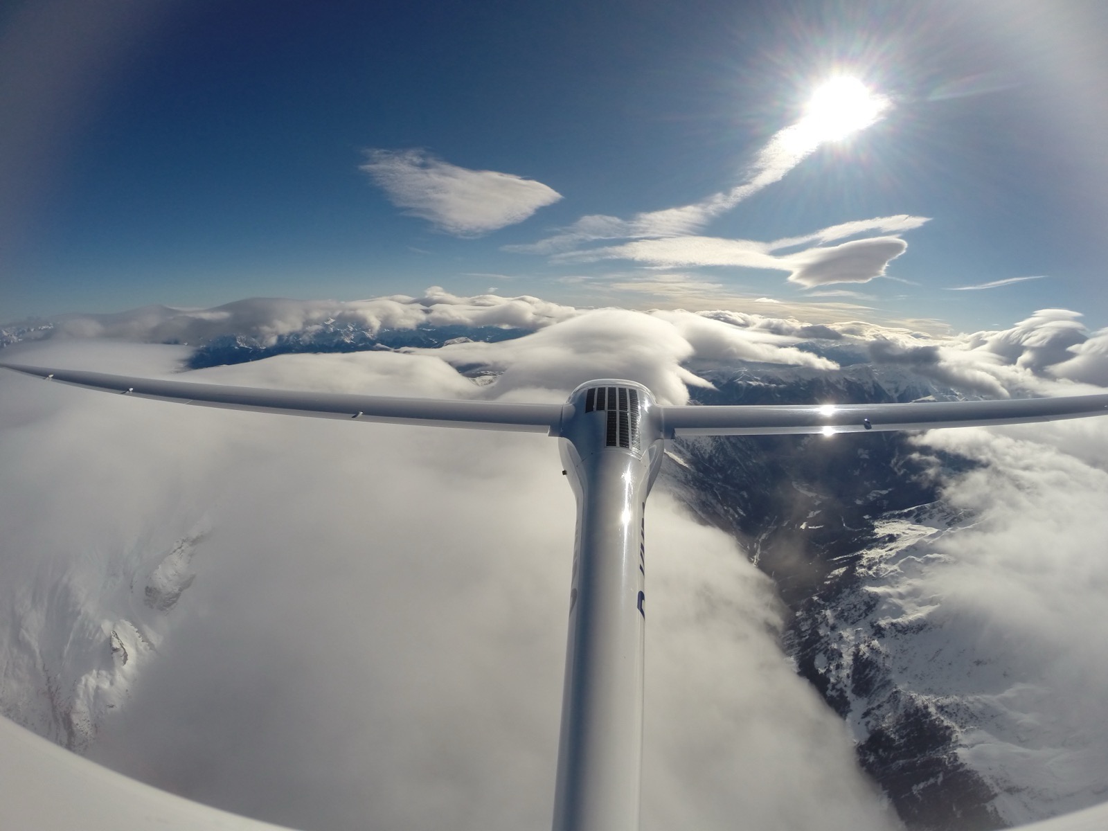 Mountain wave clouds seen from the cockpit of a sailplane.